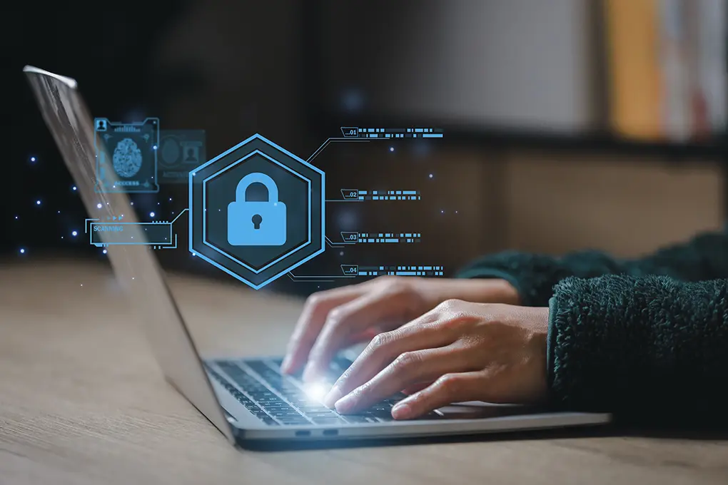 Person typing on a laptop with digital cybersecurity icons, including a padlock, representing data protection