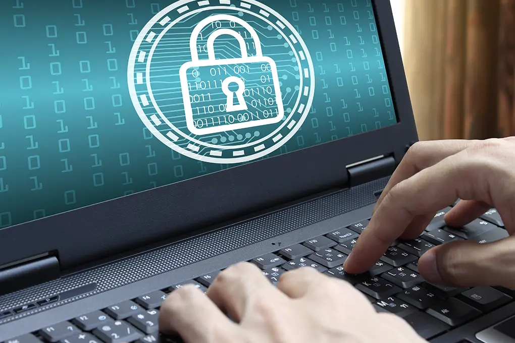 Hands typing on a laptop with a large padlock icon on screen, set against binary code, symbolizing a password manager and data protection